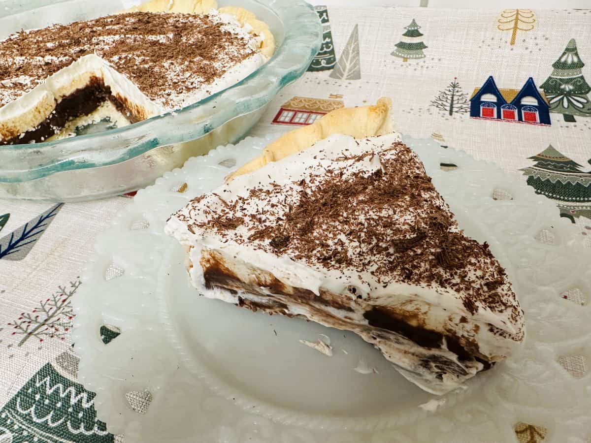 A slice of chocolate cream pie on a plate.