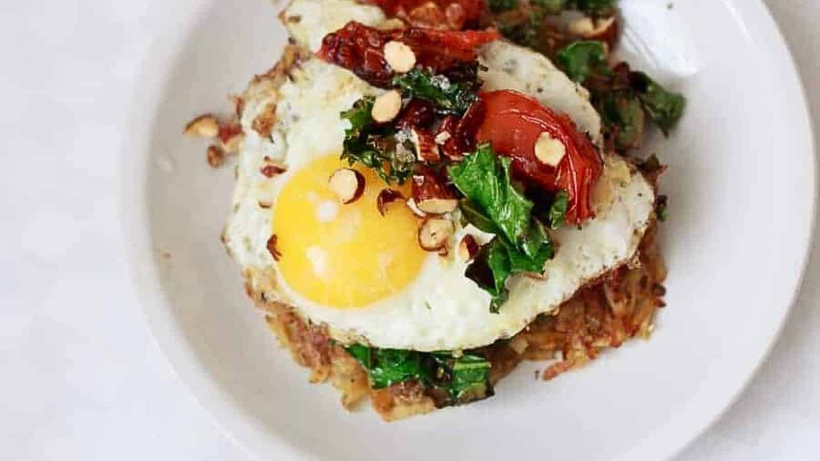 A plate topped with a fried egg and greens.