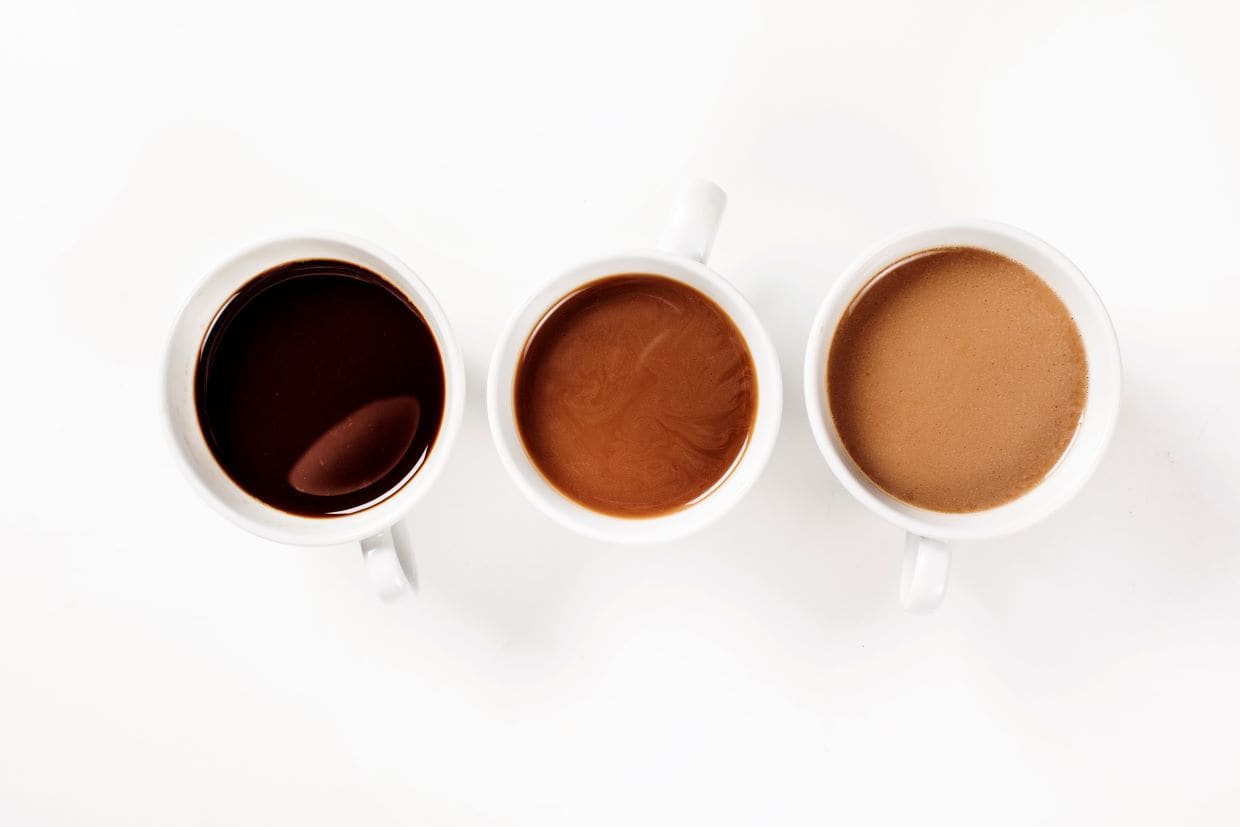 Three cups of coffee on a white background.