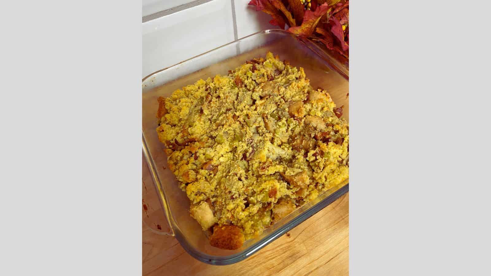 A dish of stuffing on a cutting board.