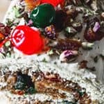 A christmas tree shaped cake on a wooden board.