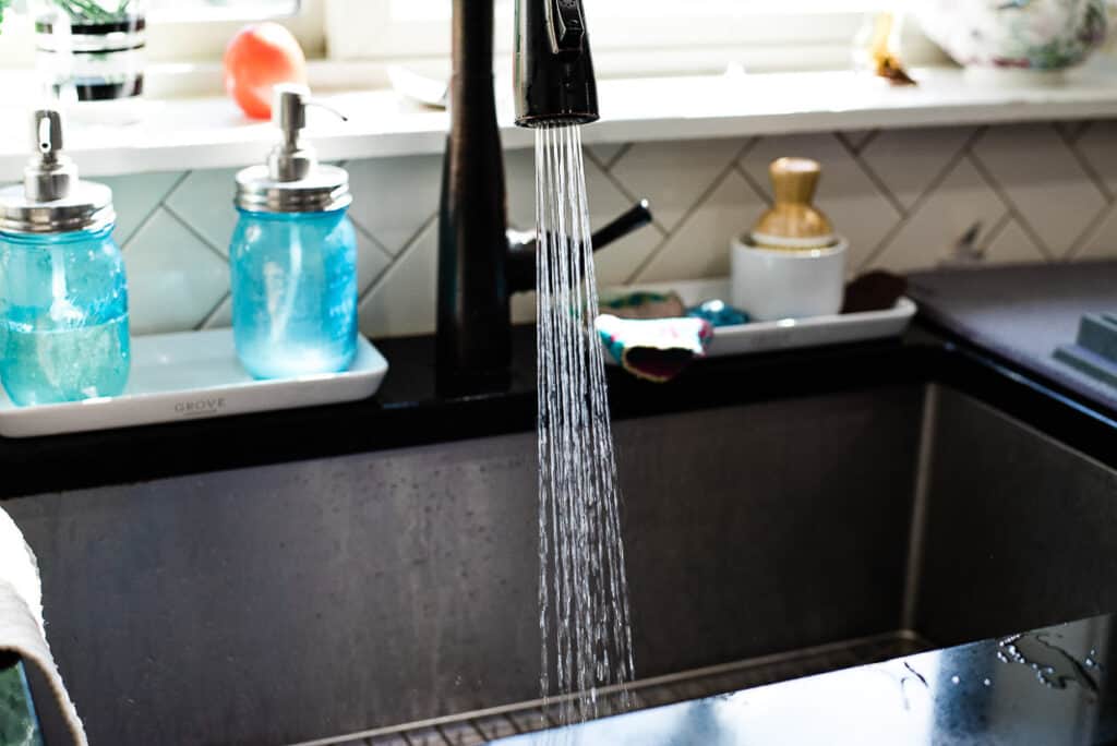 A running faucet in a kitchen sink.