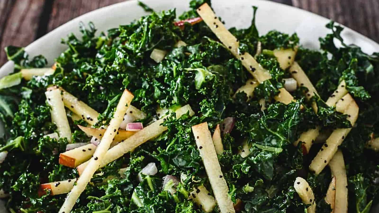 A bowl of kale salad on a wooden table.