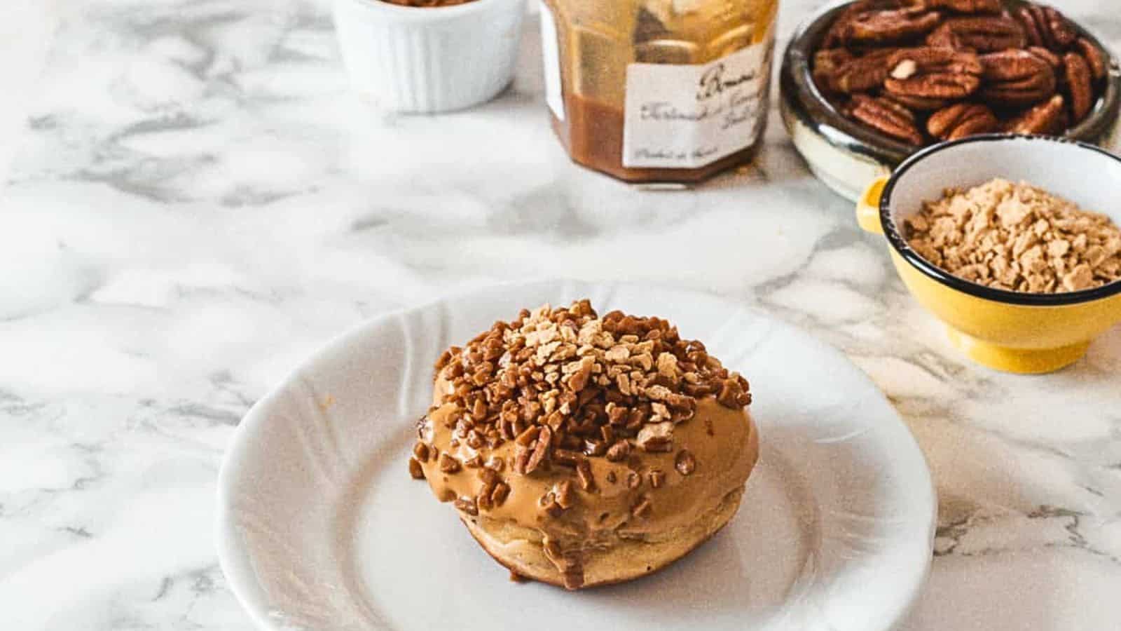 A white plate with a peanut butter doughnut on it.