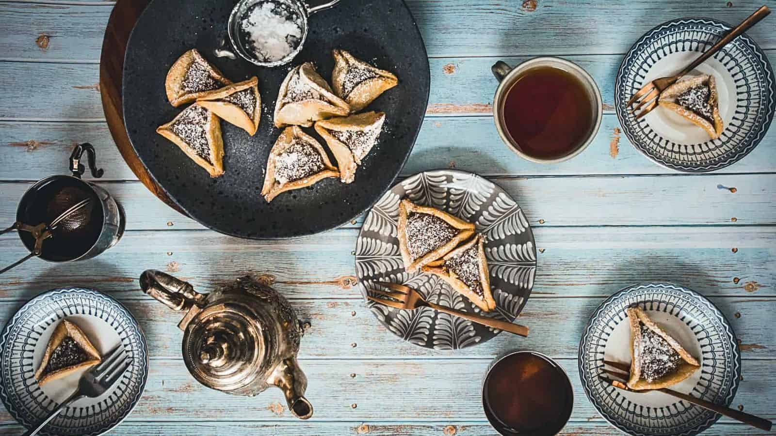 A table with tea and pastries on a wooden table.