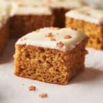 A group of pumpkin bars with icing on top.