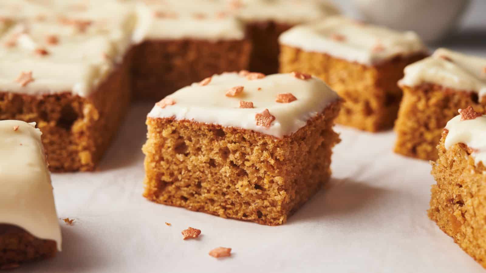A group of pumpkin bars with icing on top.