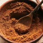 Pumpkin pie spice in a bowl with a spoon.