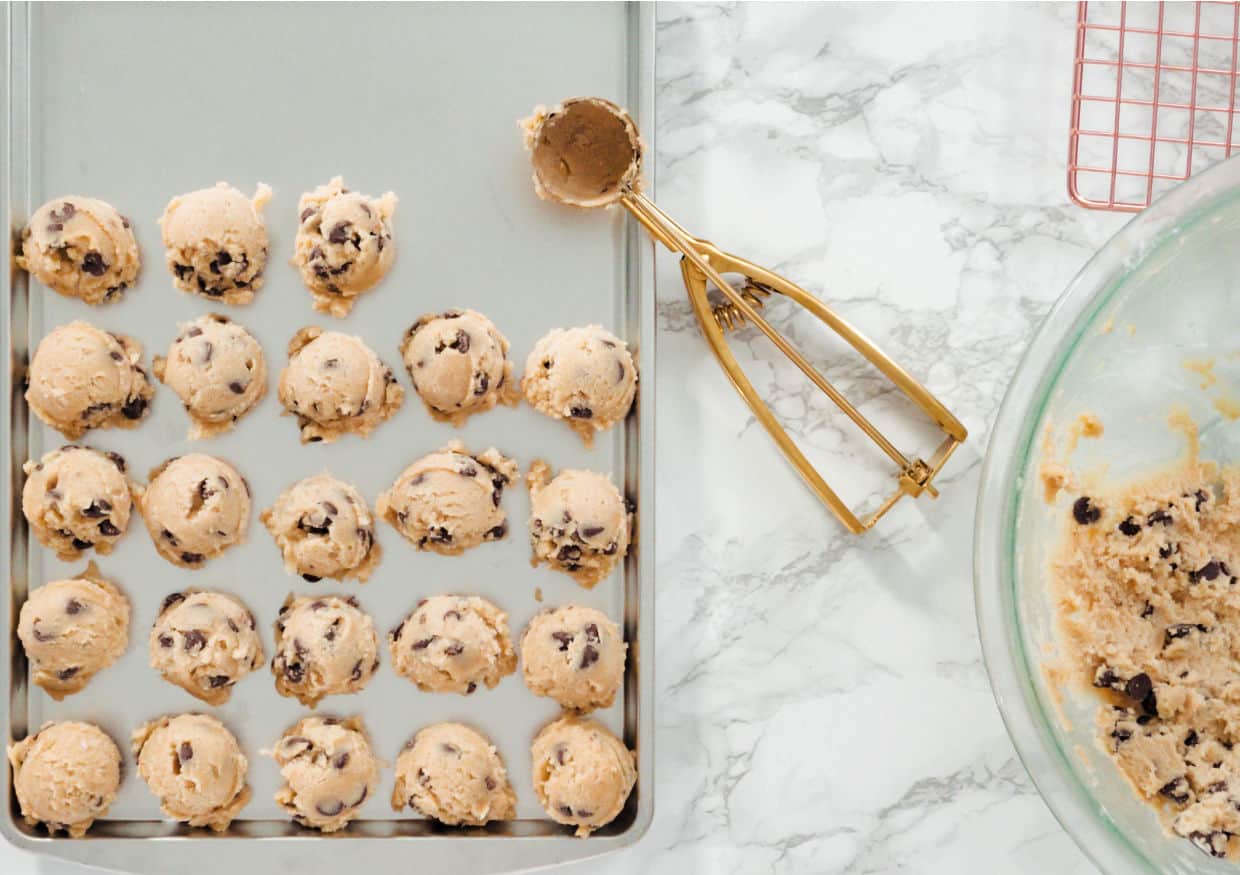 Chocolate chip cookie dough on a baking sheet.