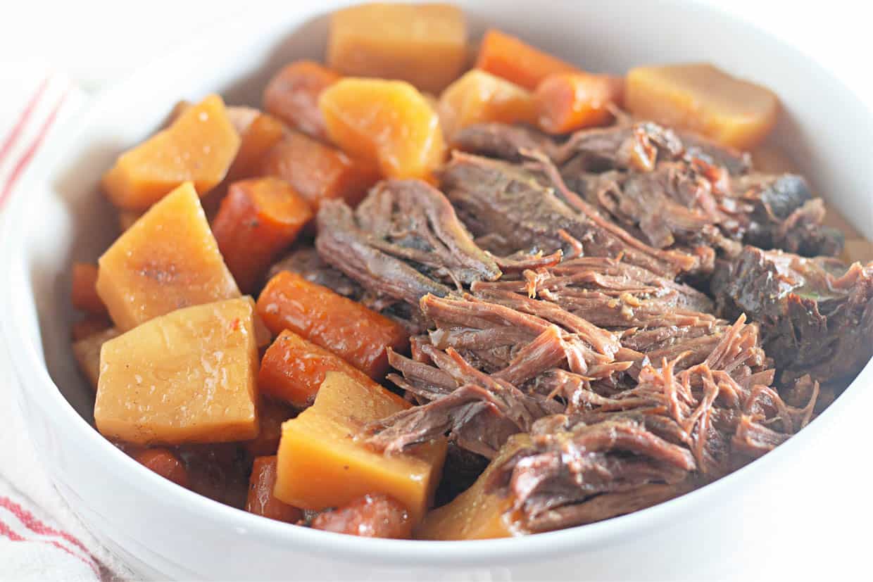 Roast beef, potatoes, and carrots in a bowl.