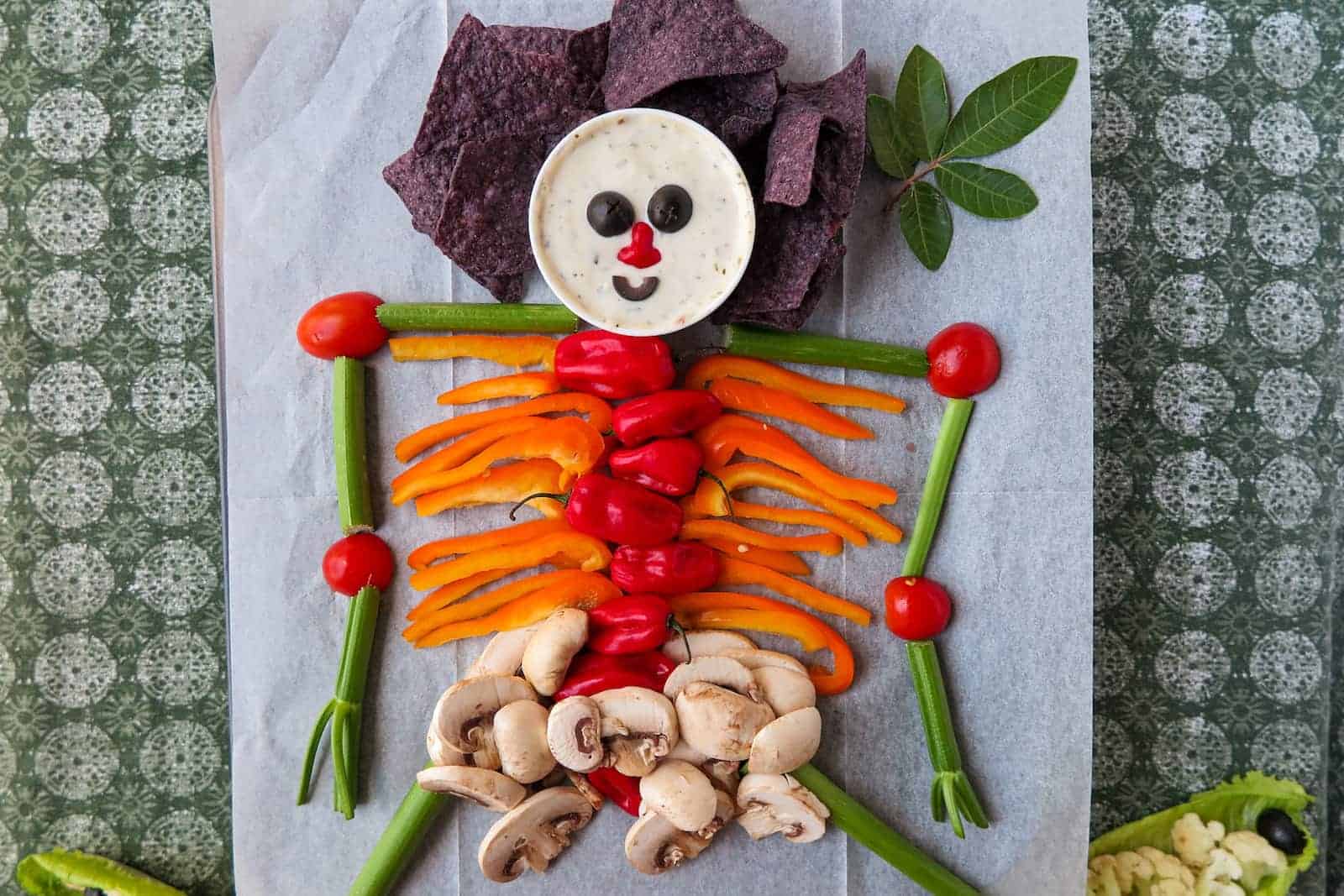 A skeleton made out of vegetables and chips.