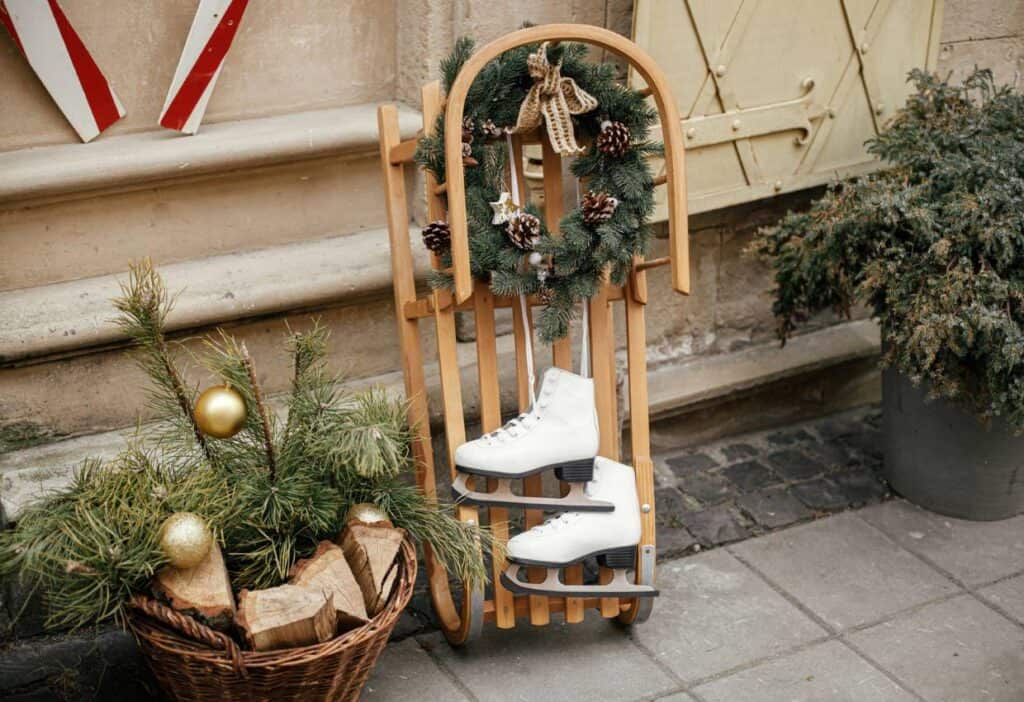 A wooden sled with a christmas wreath on it.