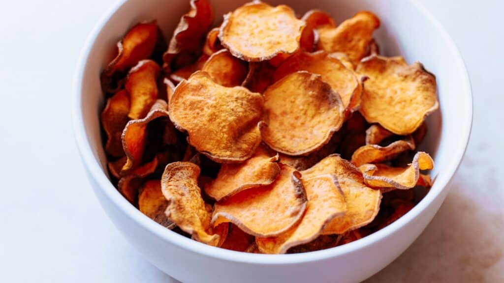 Sweet potato chips in a white bowl.