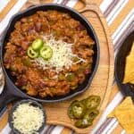 Over the Top Chili in a skillet with chips and salsa.