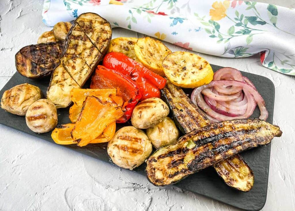 Grilled vegetables on a black slate plate