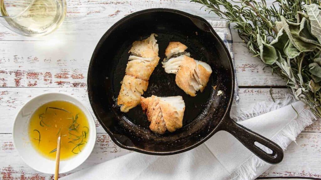 A speedy fish dinner prepared in a cast iron skillet with sprigs of thyme.