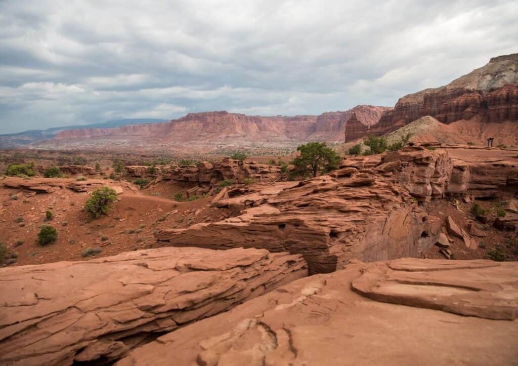 Rugged red rocks under a cloudy sky at Canyonlands National Park in Utah.