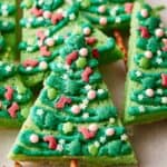 Christmas tree shaped cookies on a baking sheet.