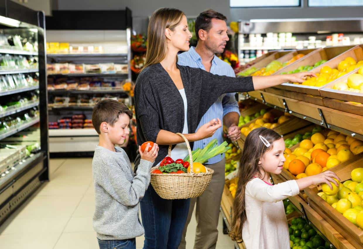 Family buying fruits and vegetables in a supermarket.