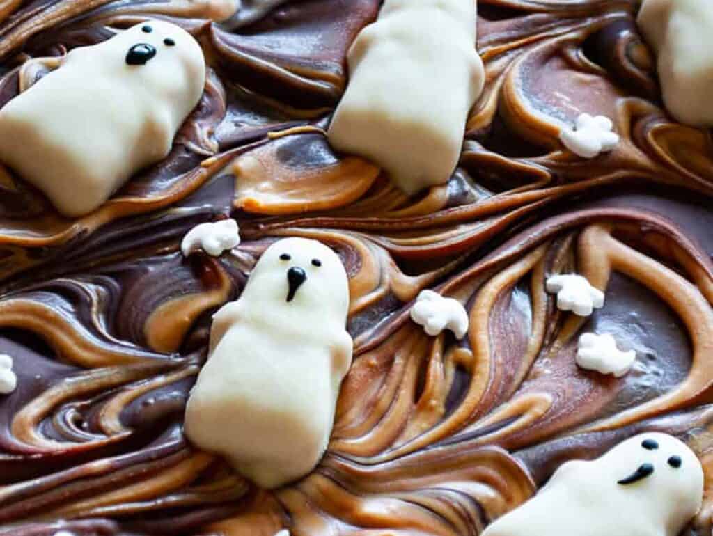 A chocolate bark with ghosts on top.