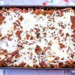 Spaghetti with meat and cheese in a baking dish.