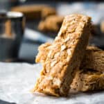 A stack of peanut butter oatmeal bars on a piece of paper.