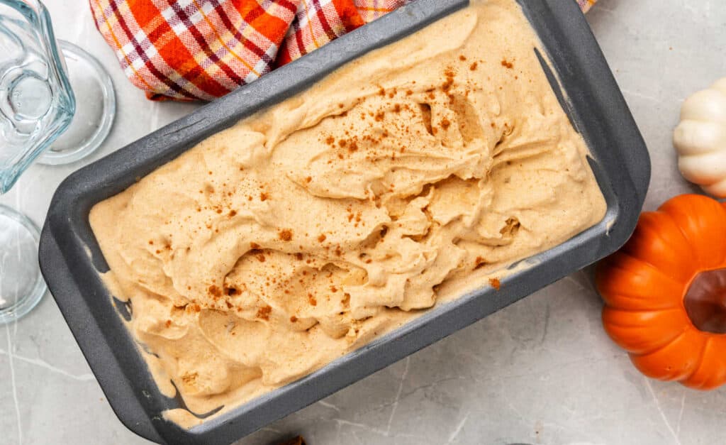 Pumpkin spice ice cream in a metal pan.