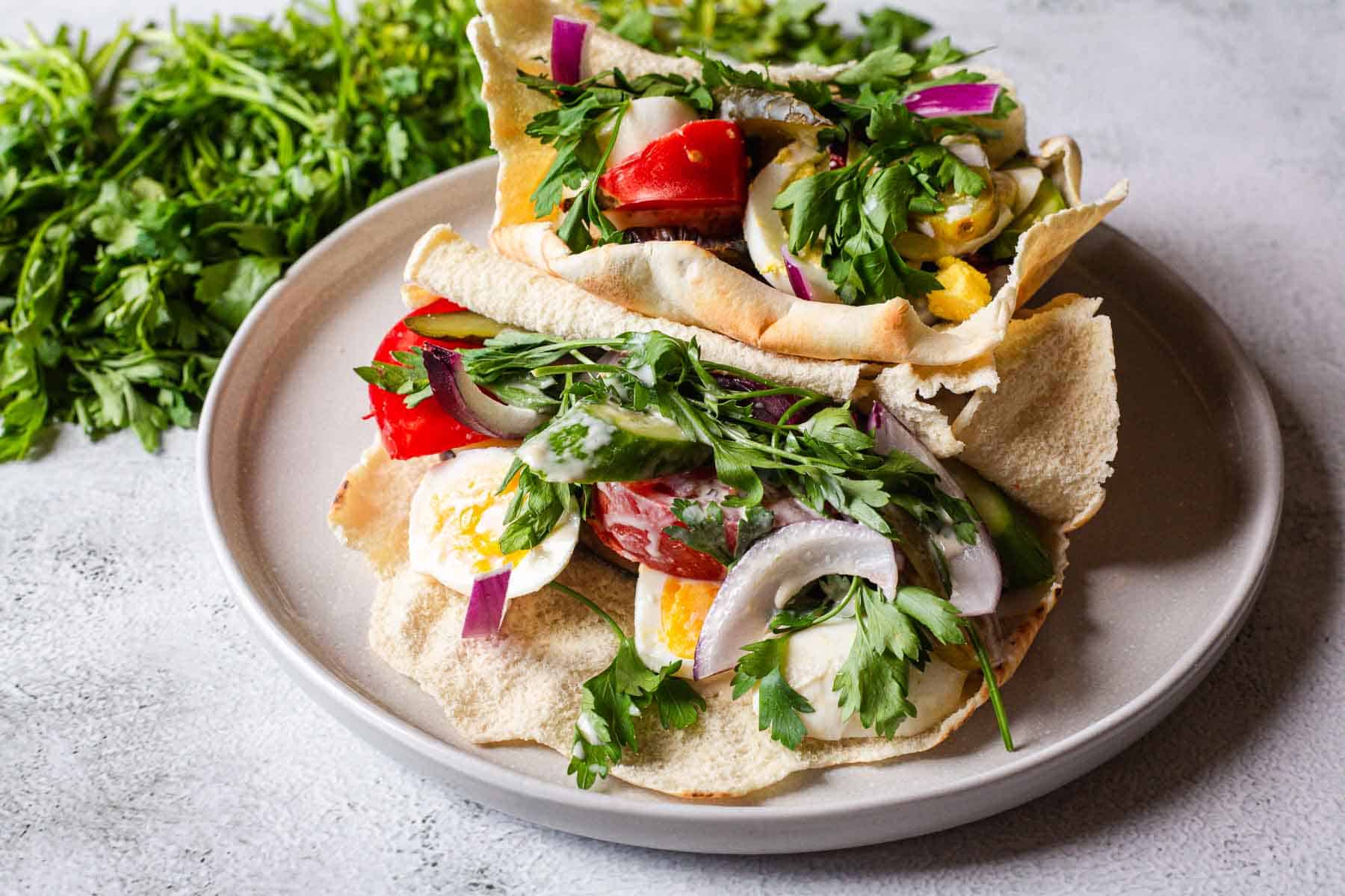A plate with pitas and vegetables on it.
