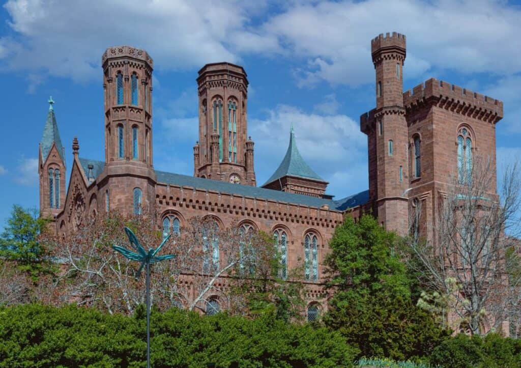 Smithsonian Castle is a large brick building with turrets on the Mall in Washington, DC.