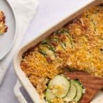 A casserole dish with zucchini and cheese on it.
