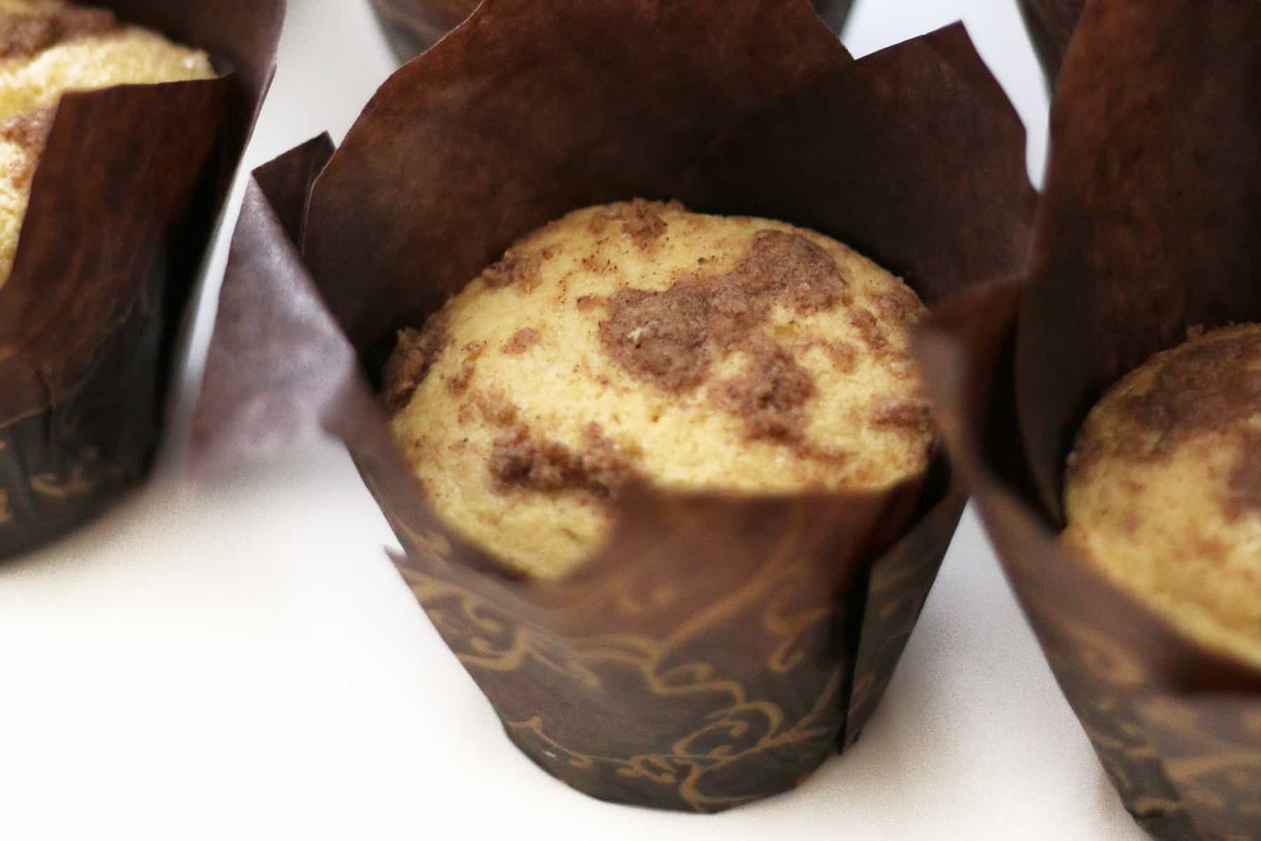 Chai struesel muffins in brown wrappers.