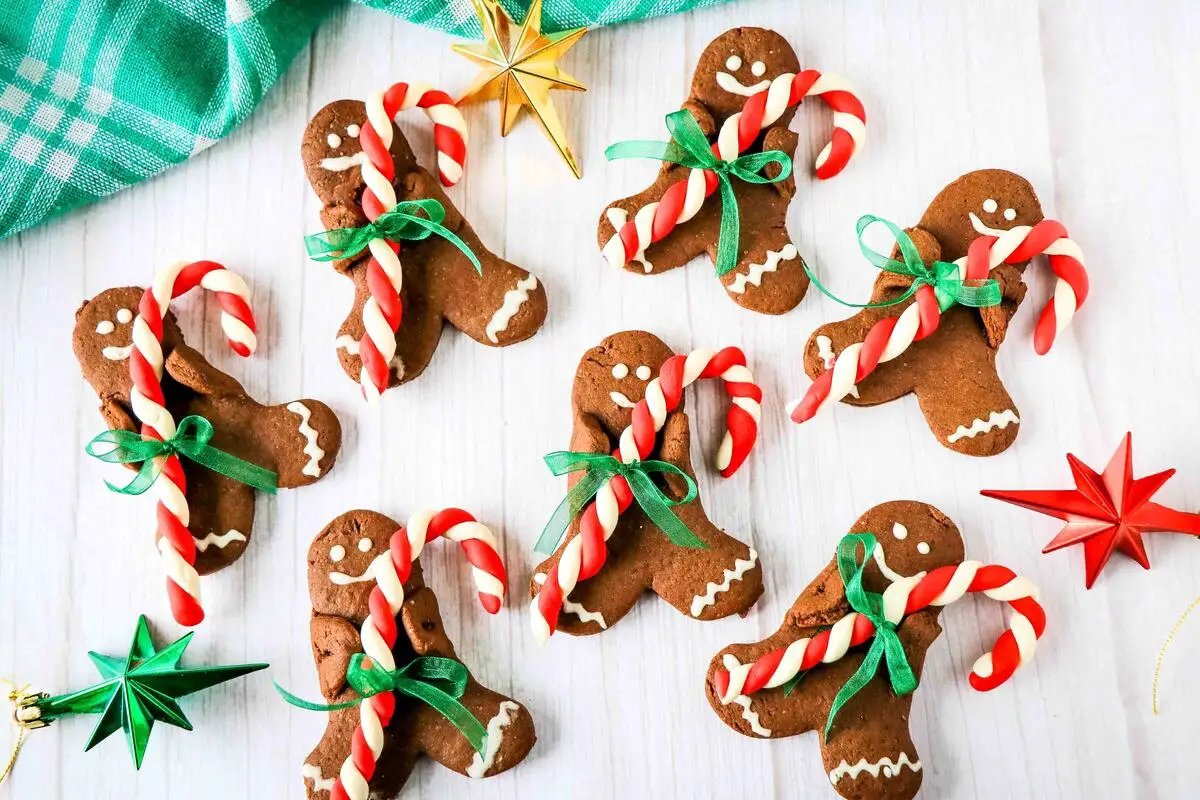 Gingerbread cookies with candy canes on a table.