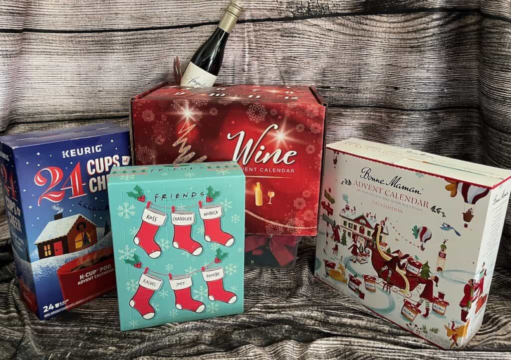 Three adult advent calendars with stockings and a bottle of wine.