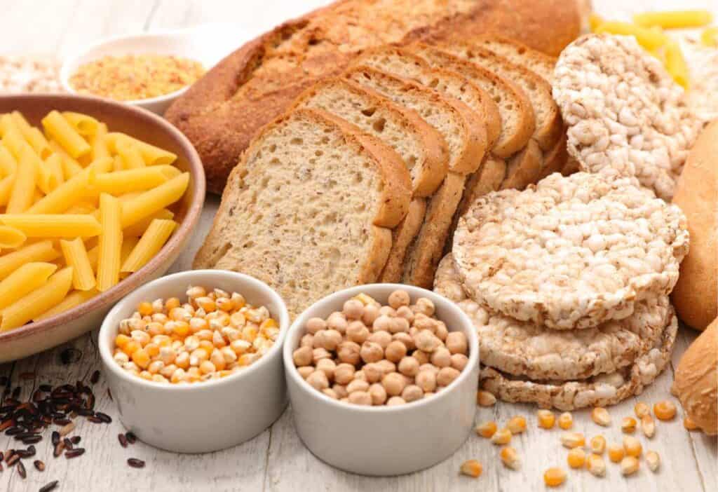 A variety of gluten-free foods including bread, pasta, and corn.