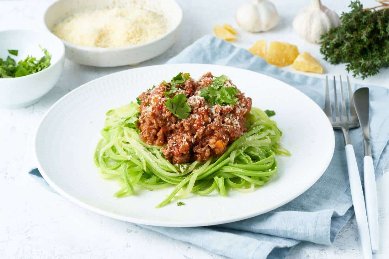 A plate with low carb spaghetti and meat on it.
