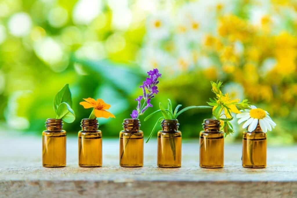 Bottles of natural essential oils for stress relief, infused with flowers.