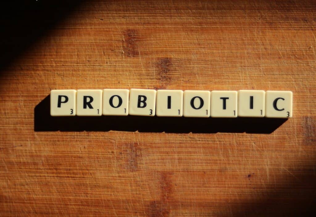 The word probiotic is spelled out on a wooden table.