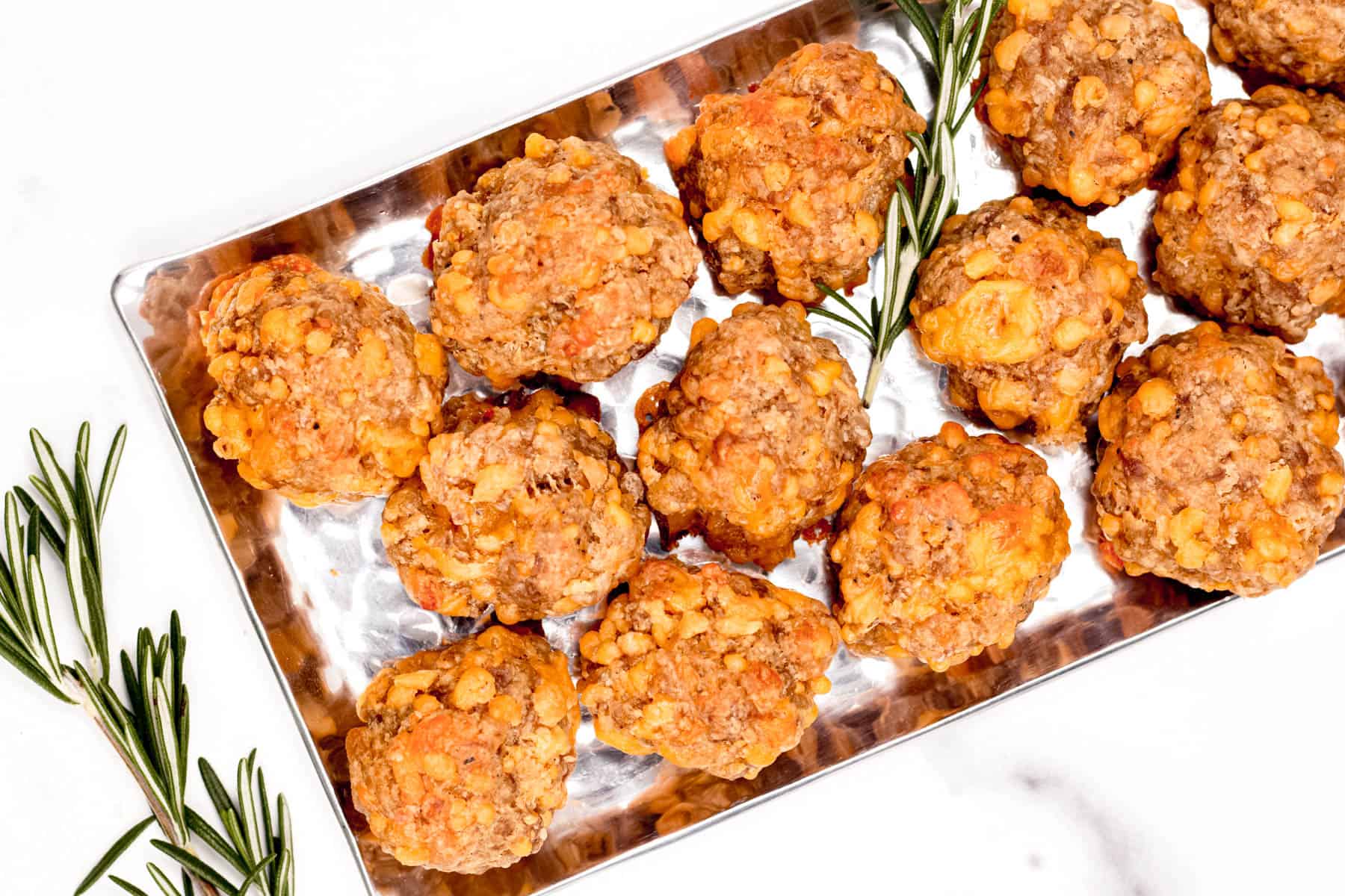 Sausage balls on a Tray with Rosemary Sprigs.