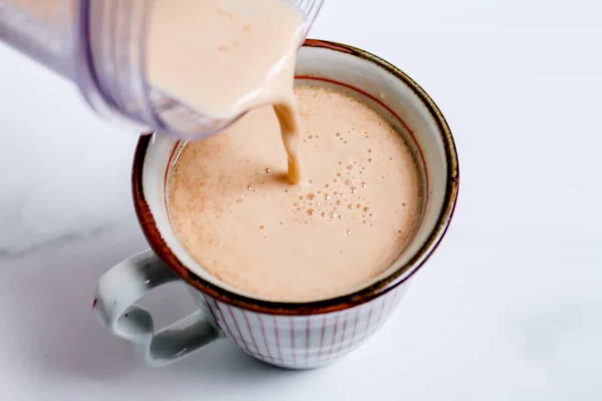 Vegan Bulletproof Coffee being poured into a mug.