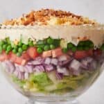 A salad bowl filled with vegetables and peas.