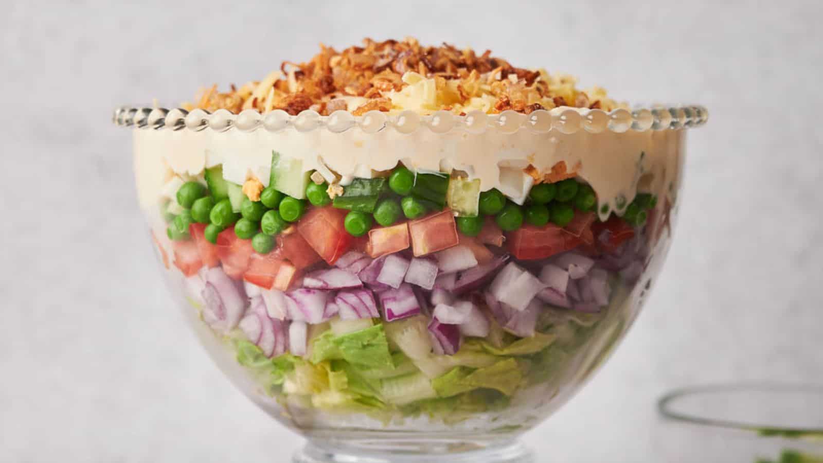 A salad bowl filled with vegetables and peas.