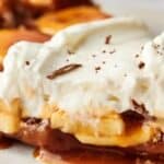 A slice of Banoffee pie with whipped cream and caramel.