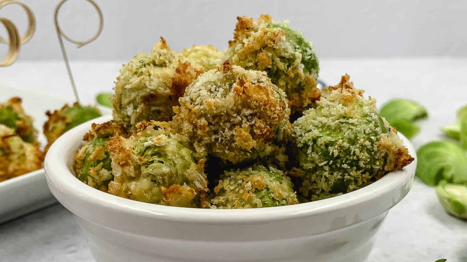 Cheesy Brussel sprouts in a white bowl.
