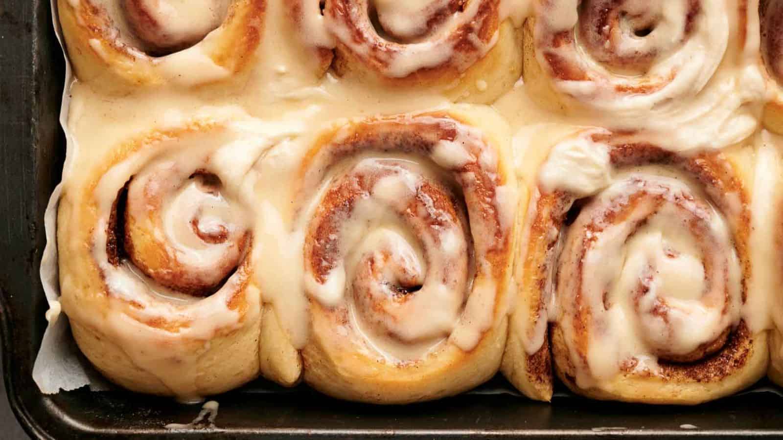 Cinnamon rolls in a pan with icing.