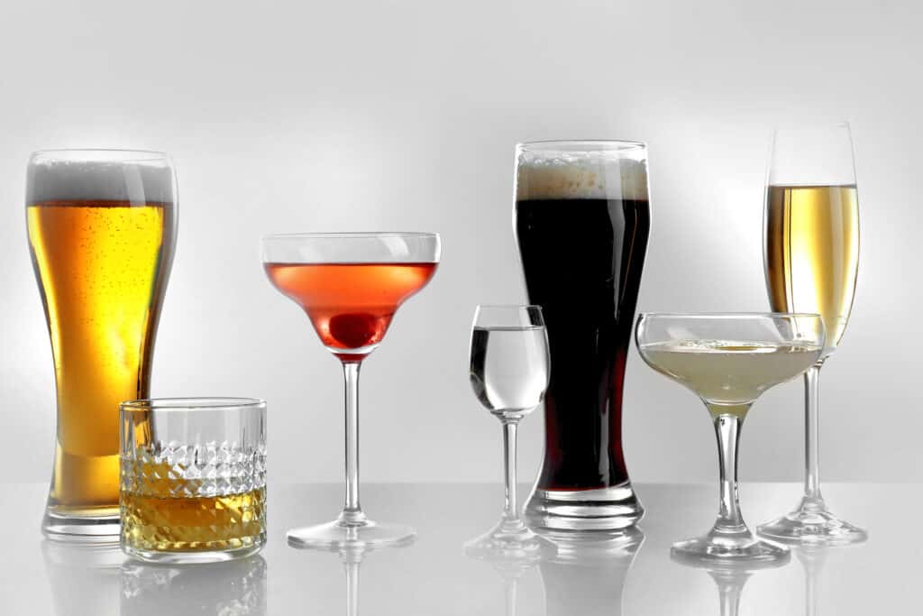 A group of glasses with different types of drinks.