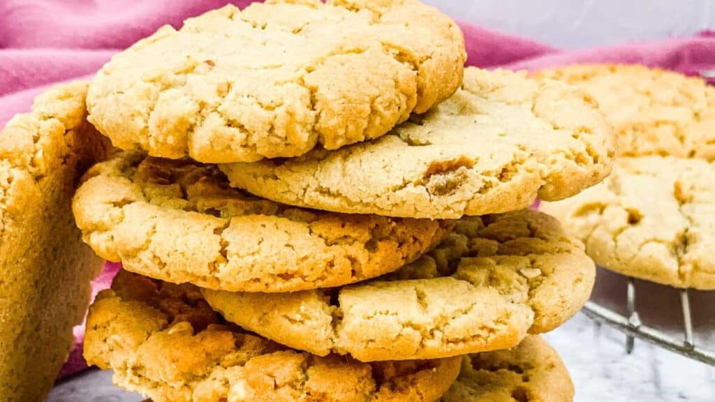 A stack of peanut butter cookies on a cooling rack.