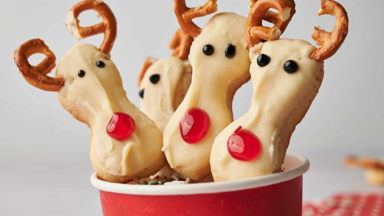 Reindeer cookie pops in a cup.