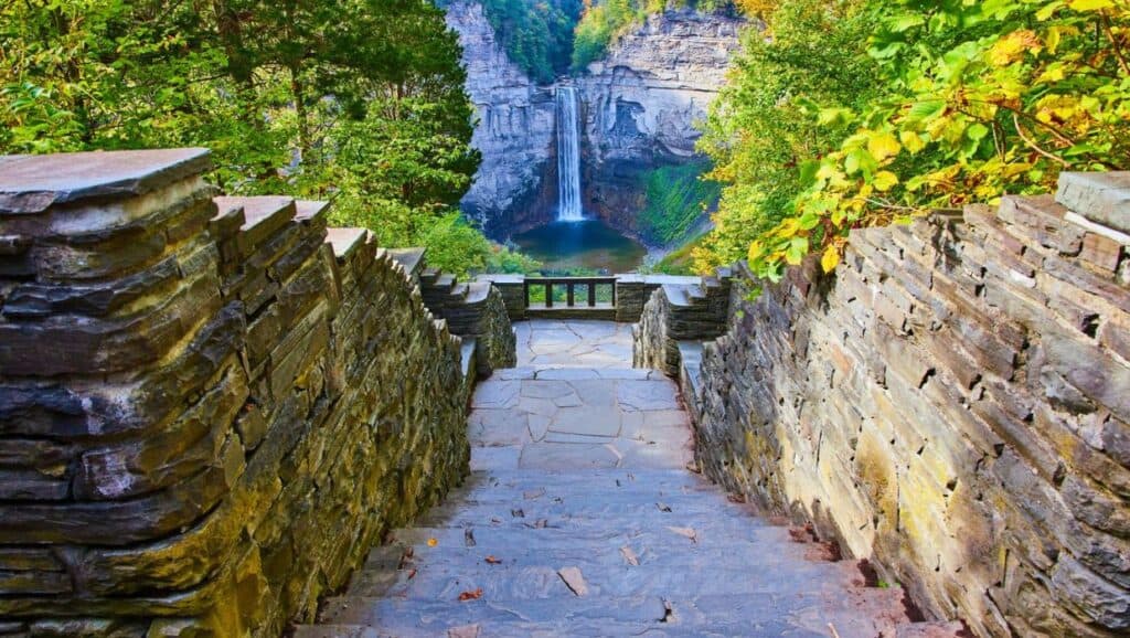 A stone staircase leading to a waterfall.