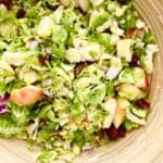 A bowl of brussels sprouts and apple salad.