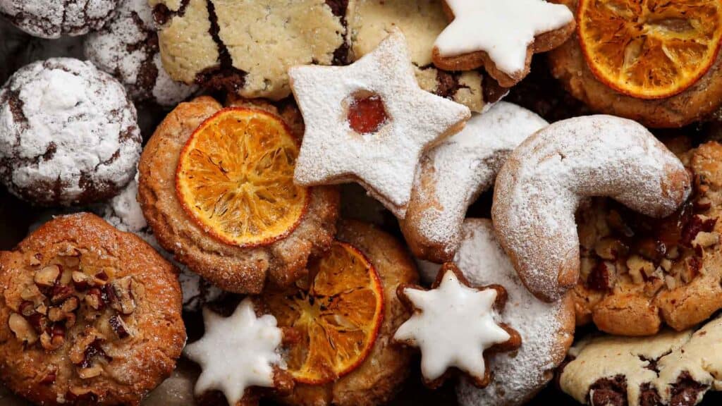 A plate of cookies with oranges and stars on it.